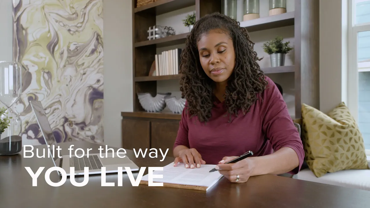 A person sitting at a table with overlay text that says: built for the way you live