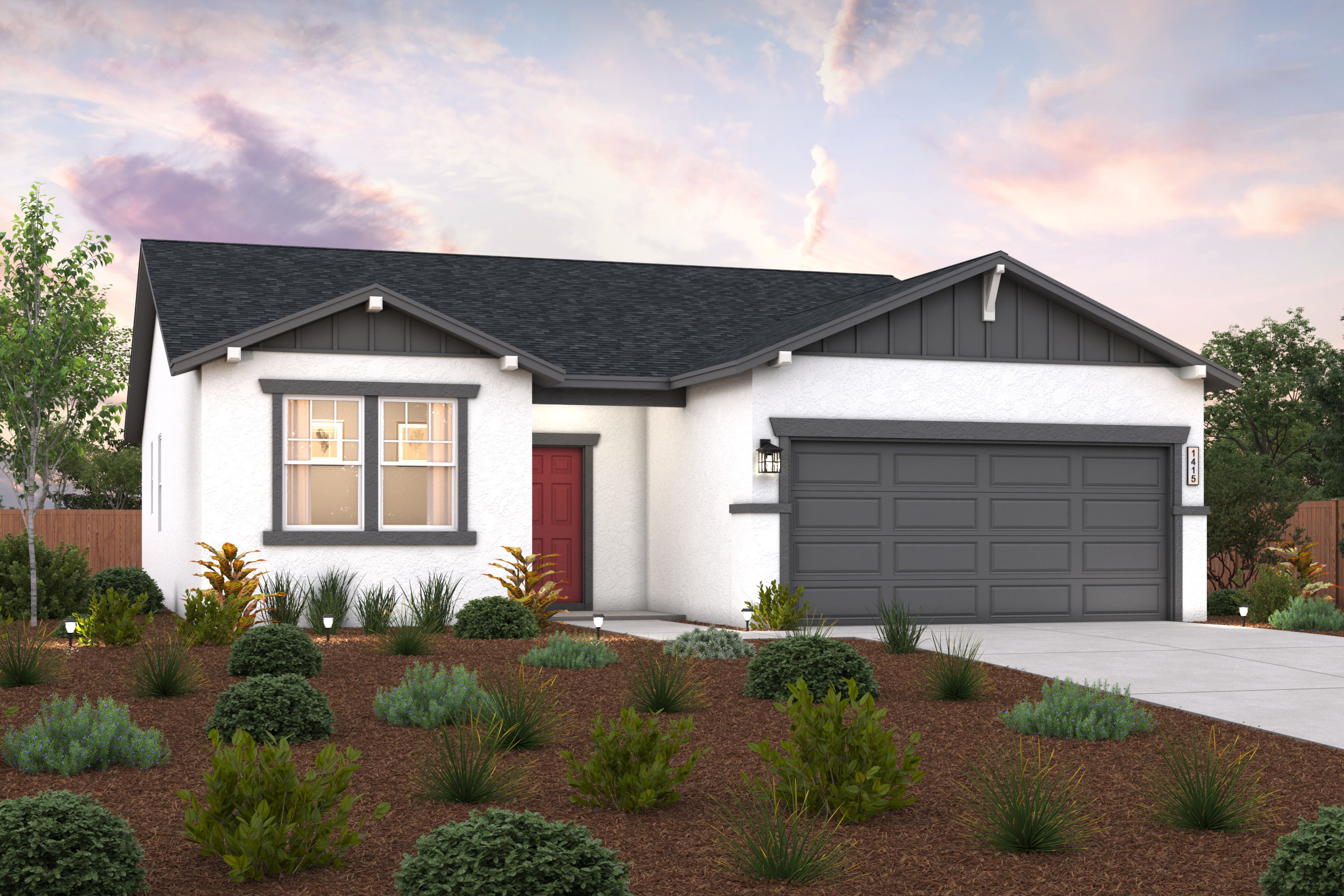 A house with a garage and bushes in front of it.