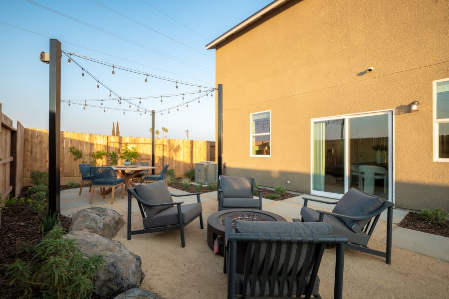A patio with chairs and tables.