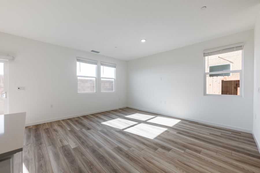 A room with a wood floor and windows.
