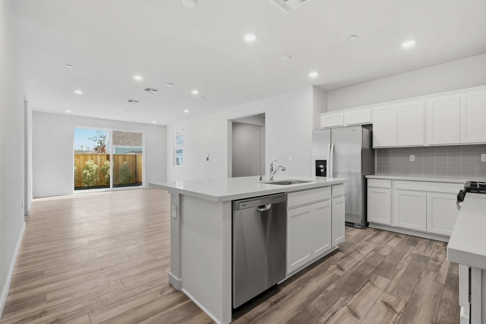 A kitchen with white cabinets.