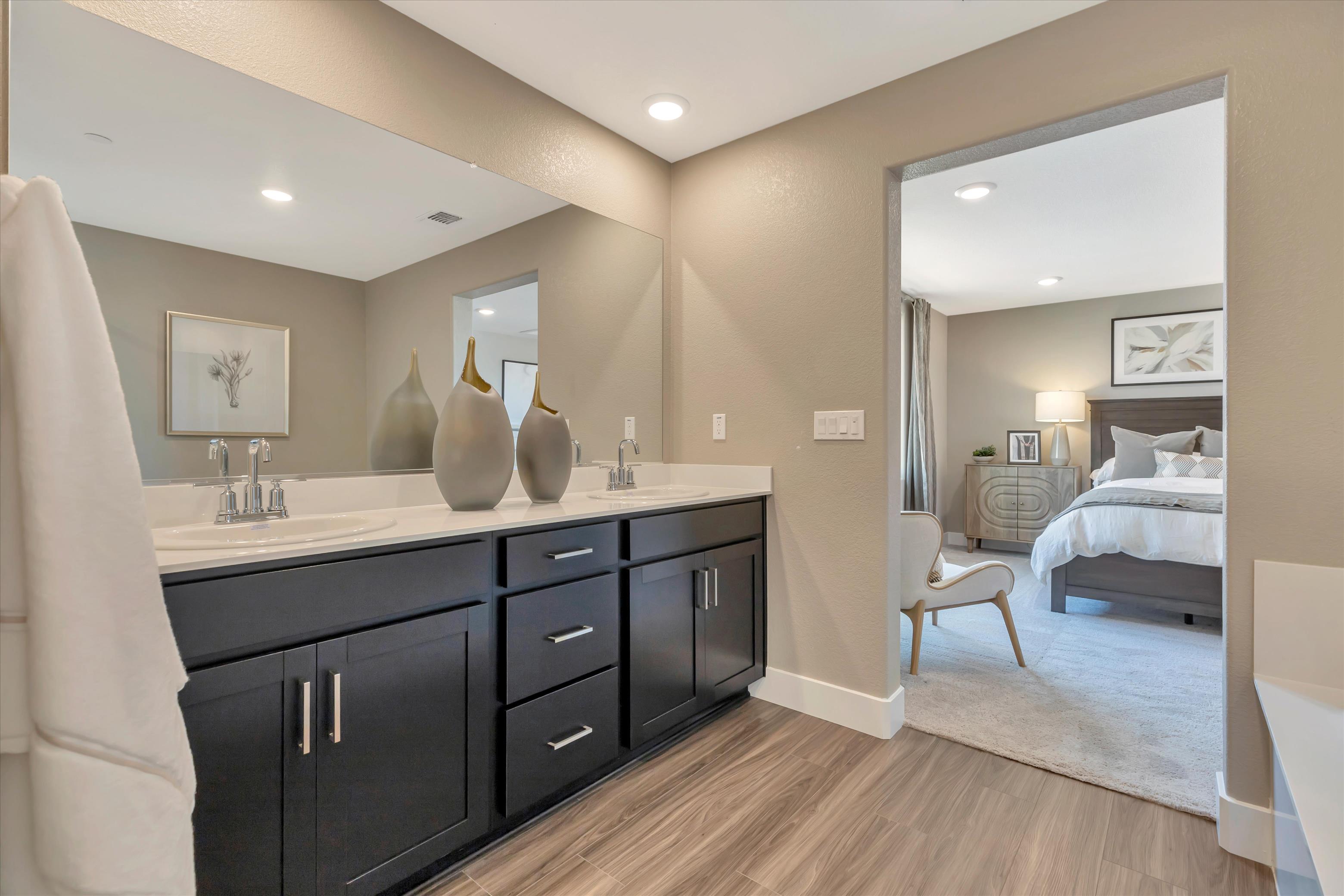 A bathroom with a bed and a mirror.