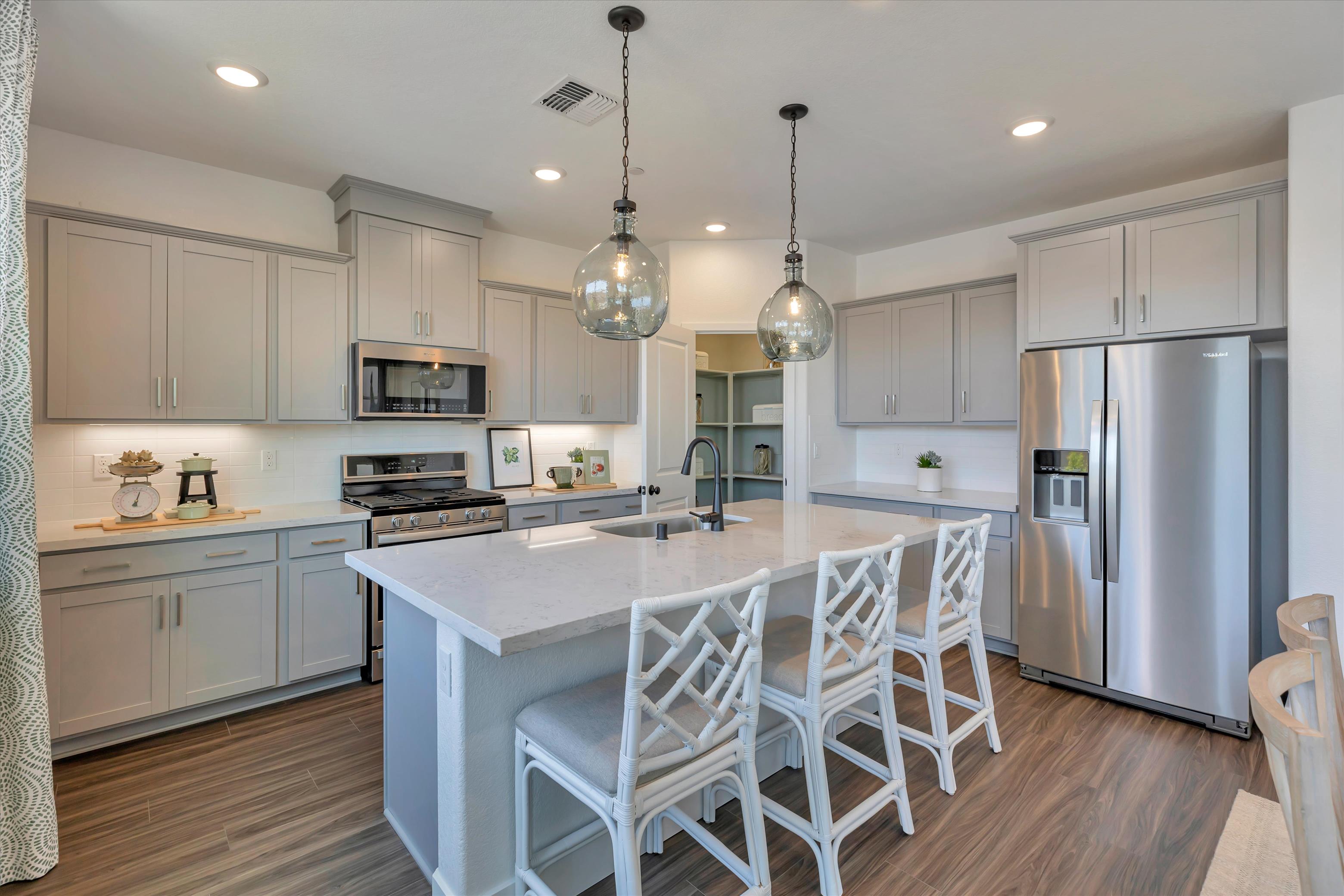 A kitchen with white cabinets.