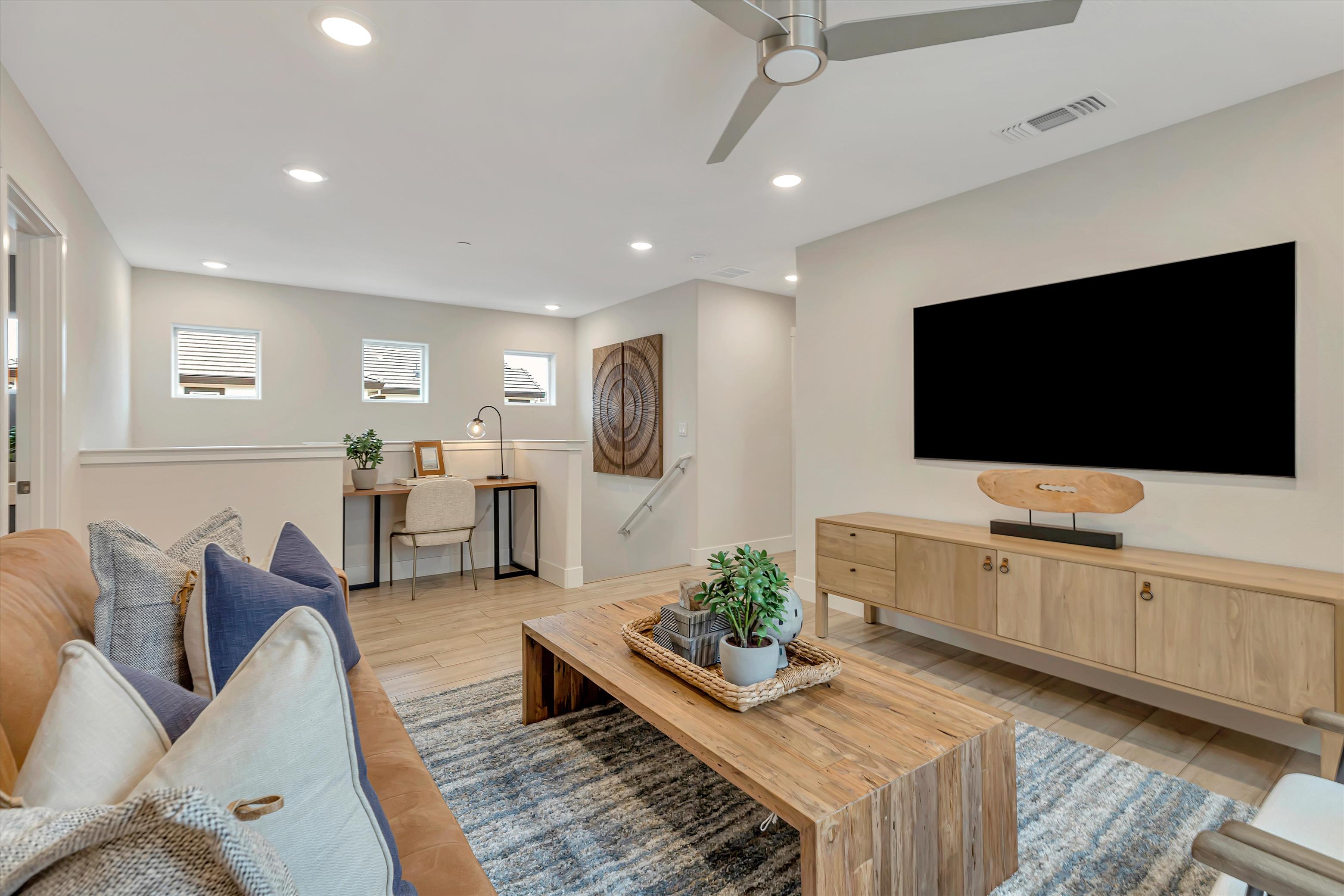 A living room with a tv and couches.