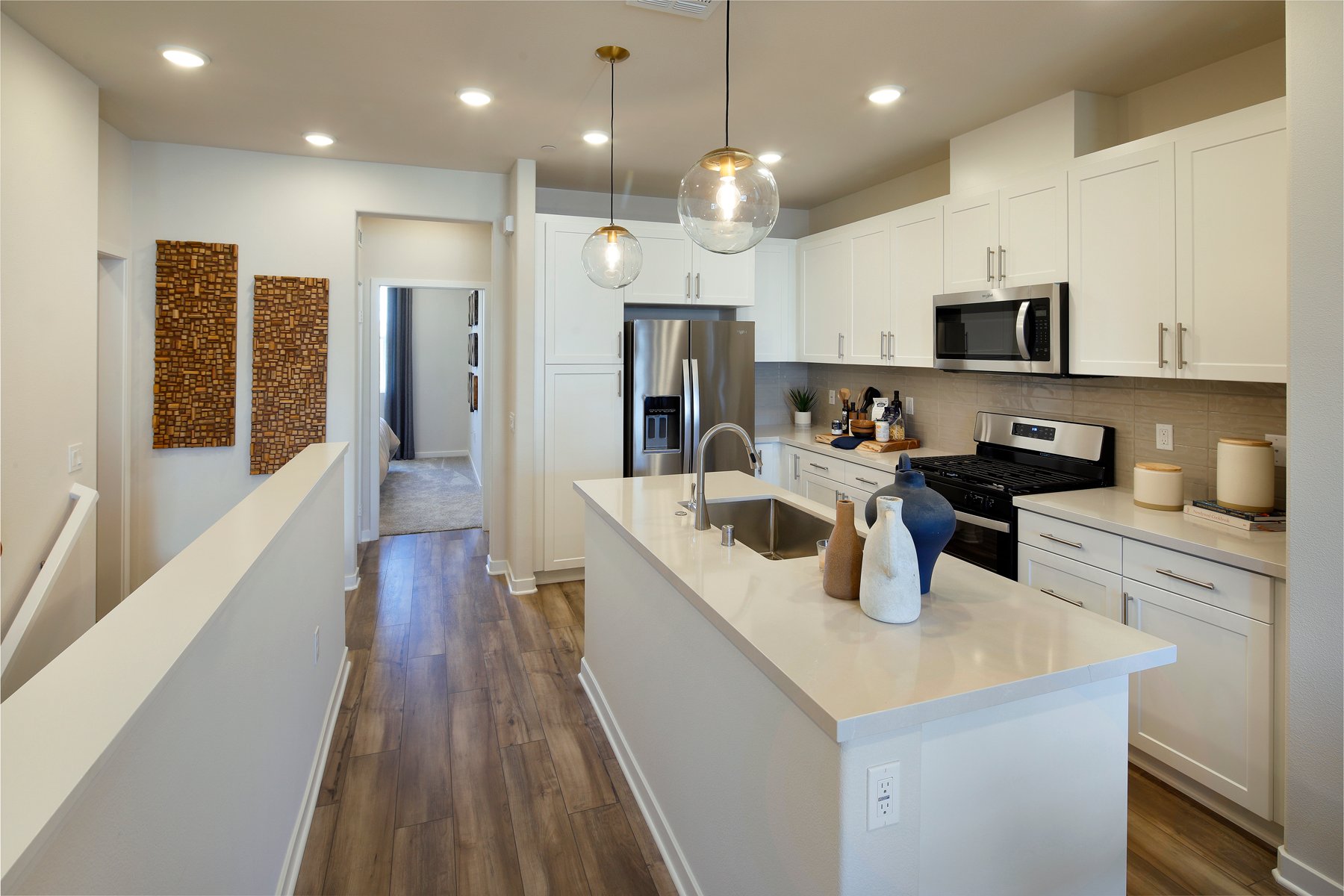 A kitchen with white cabinets.