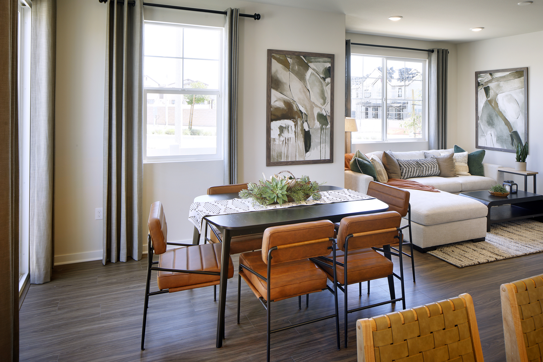 A living room with a table and chairs.