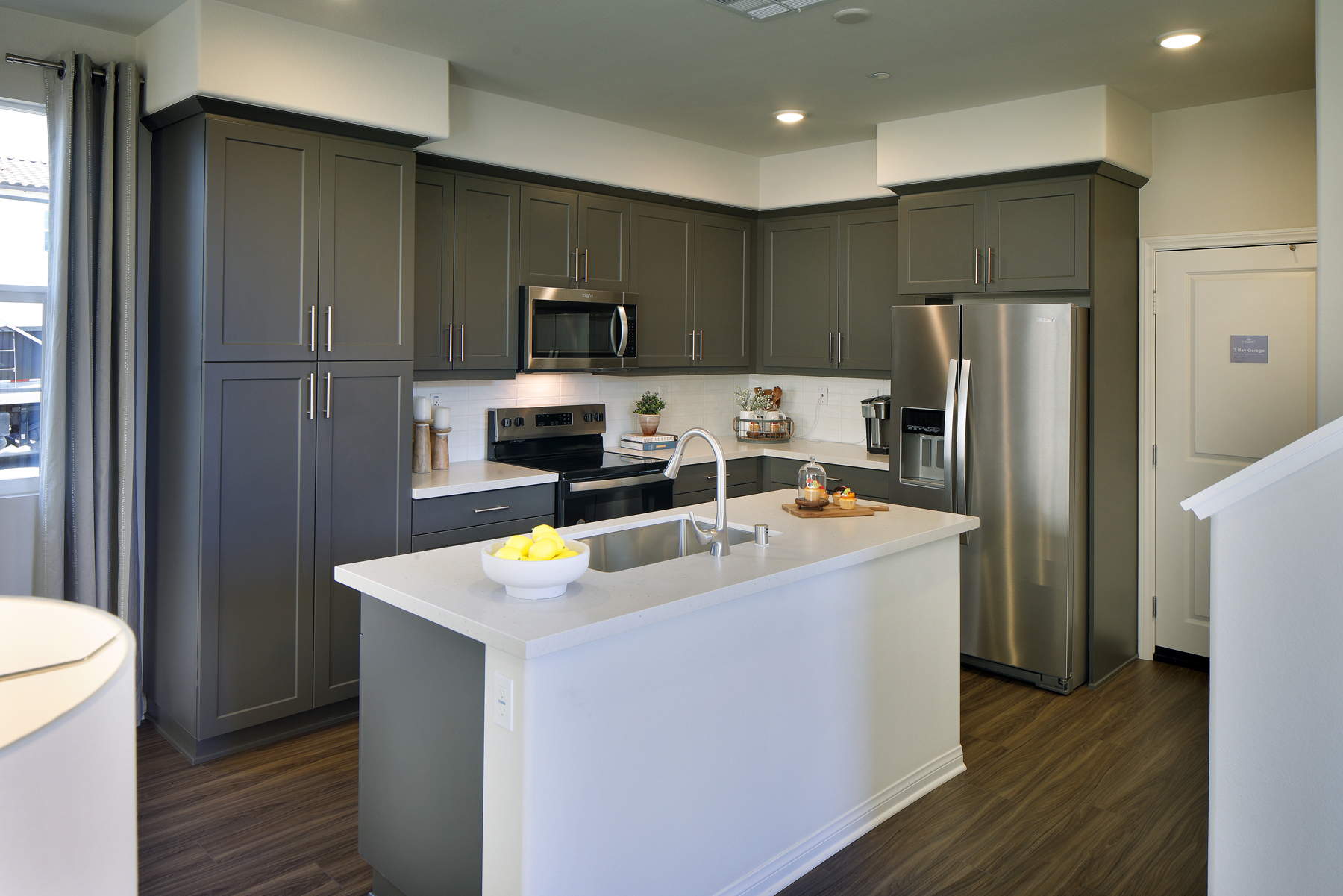 A kitchen with black cabinets.