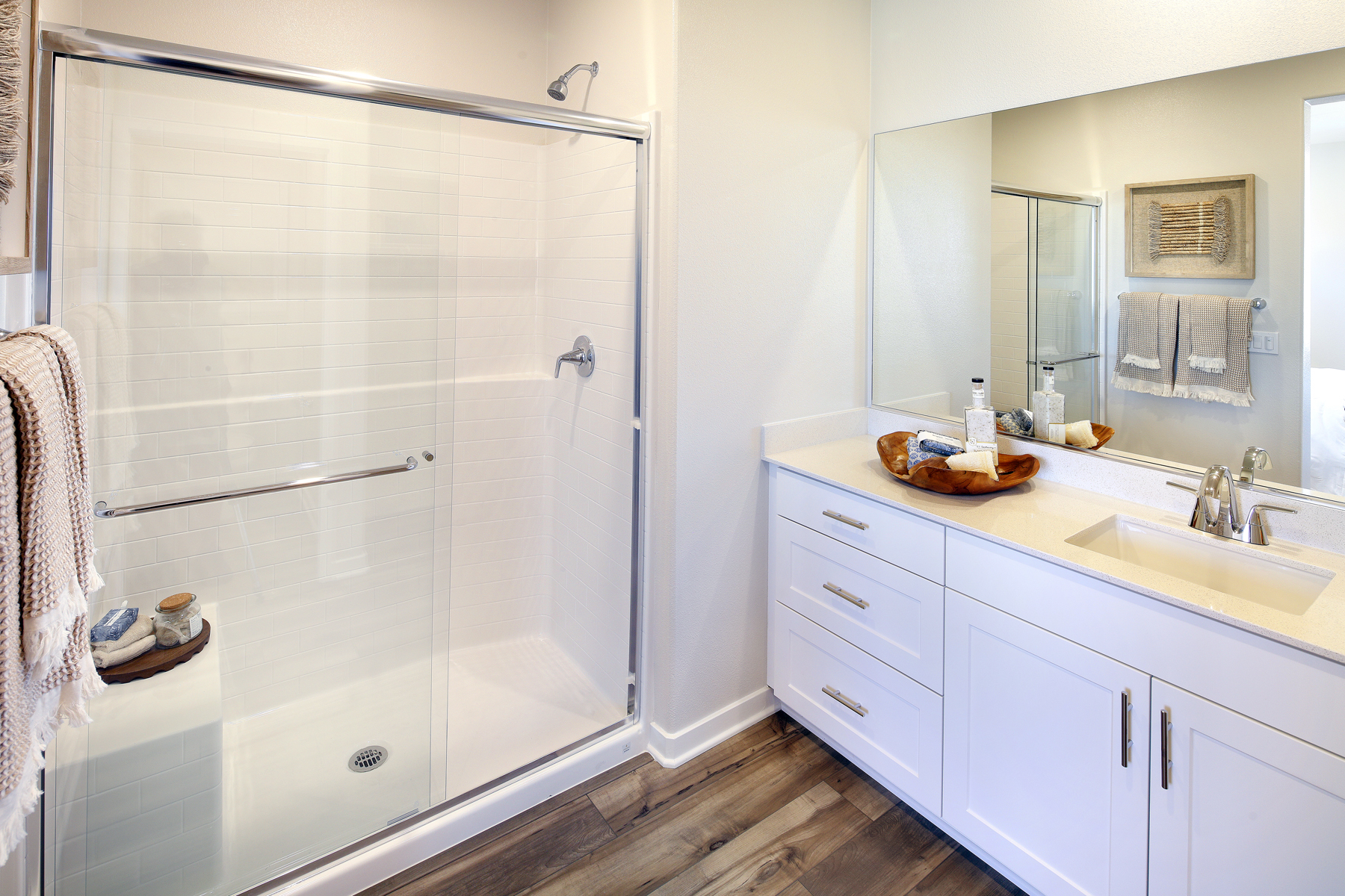 A bathroom with a shower and sink.