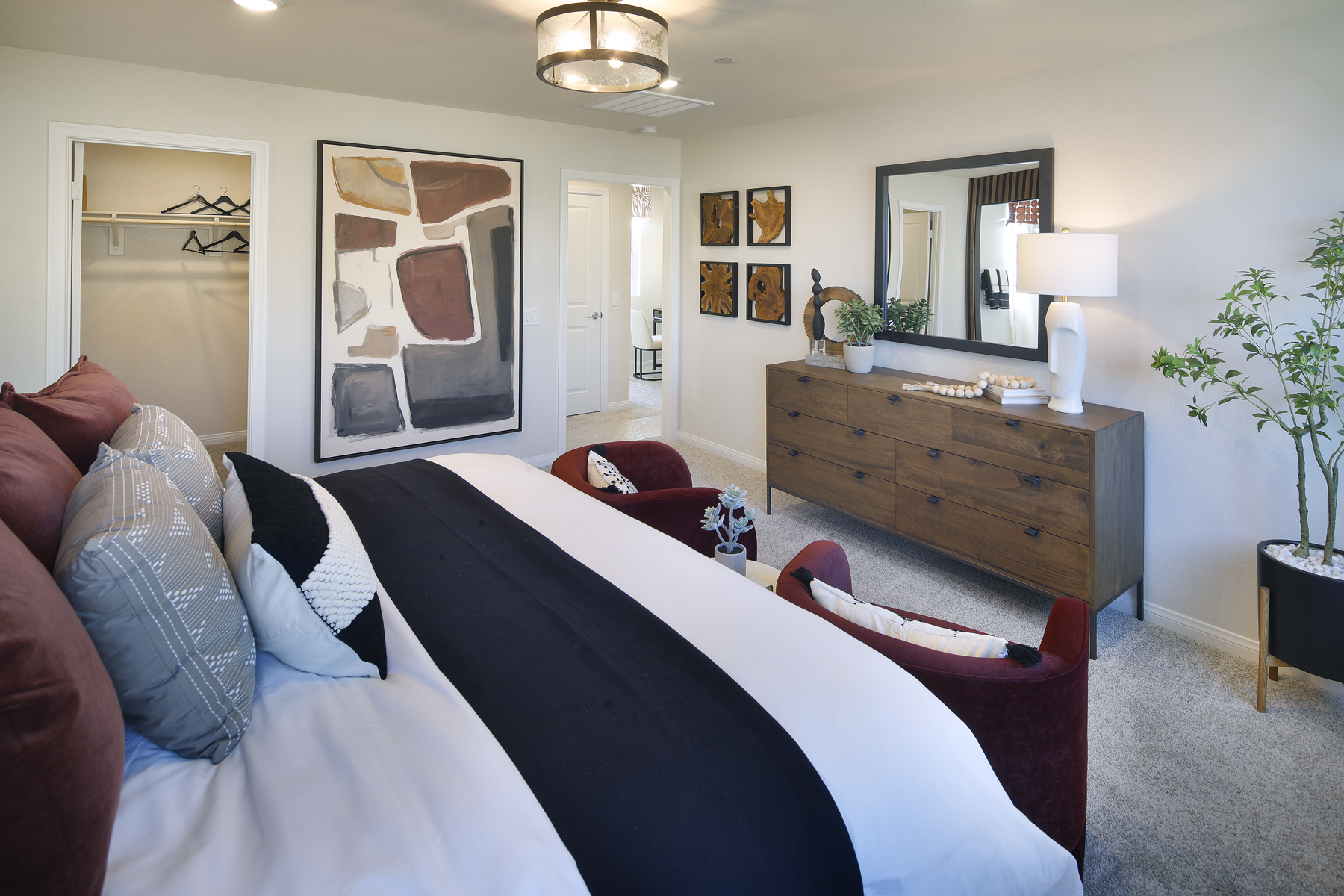 A bedroom with a bed and a dresser.