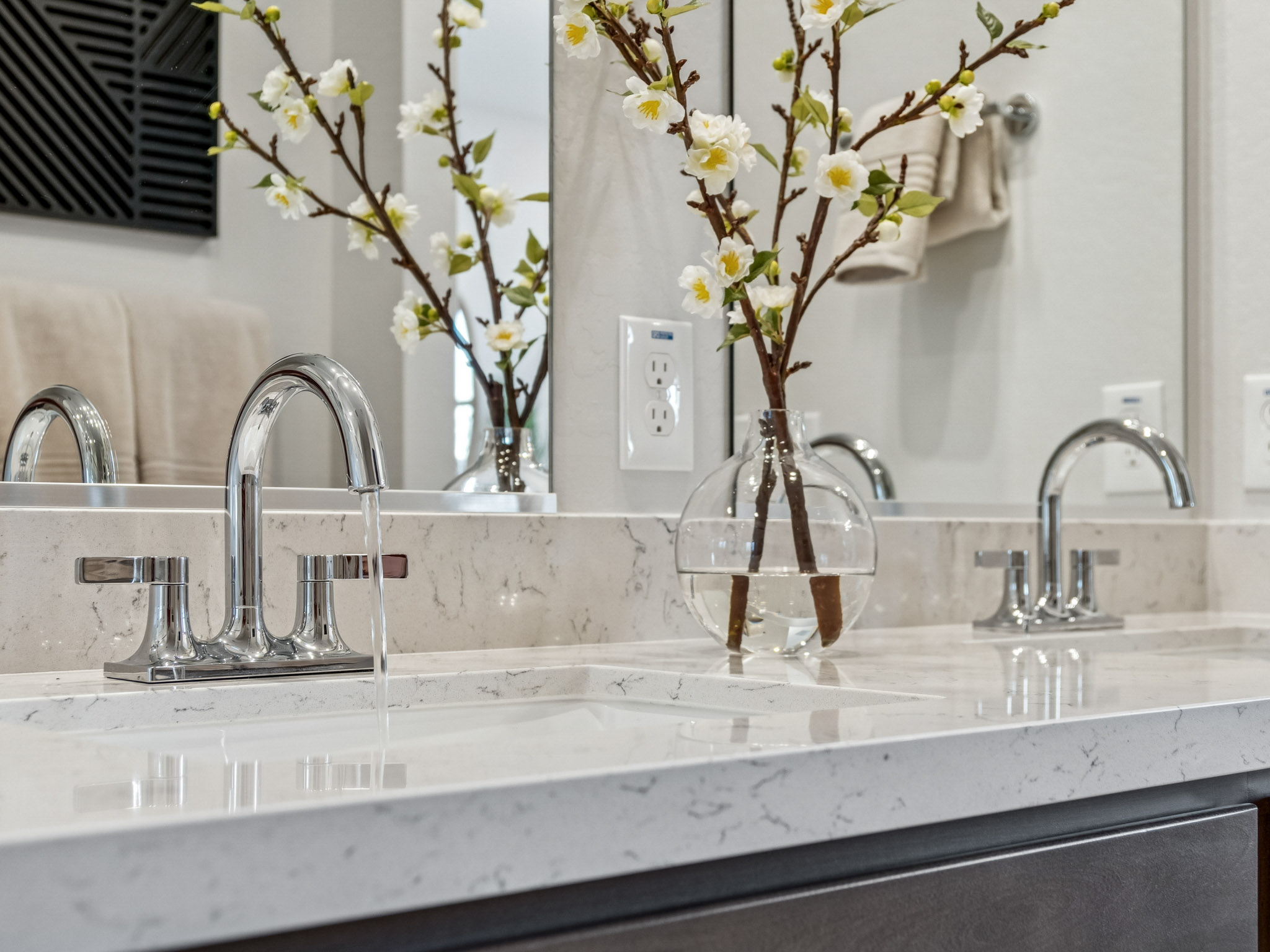 A vase of flowers sits on a countertop.