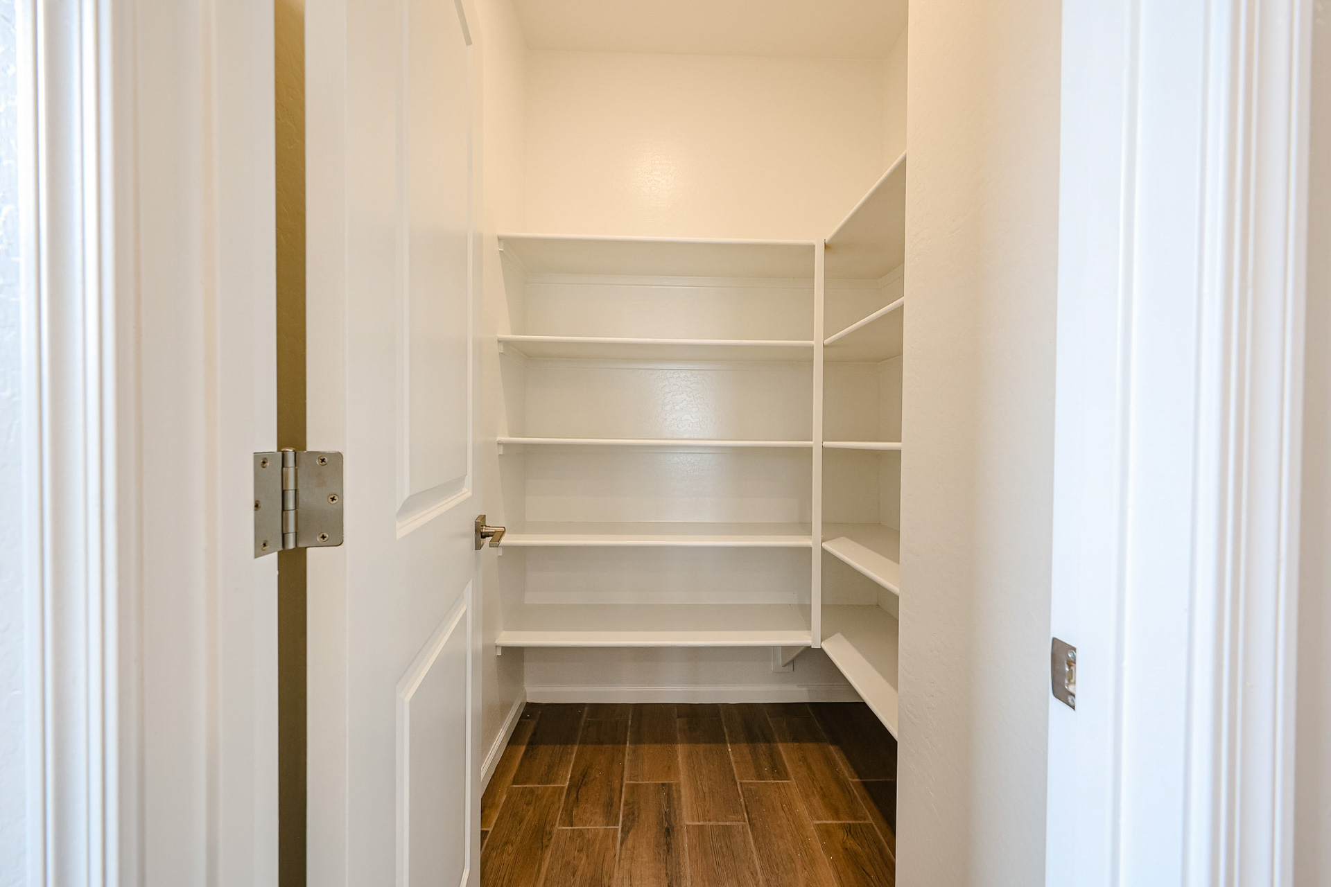 A white closet with a door.