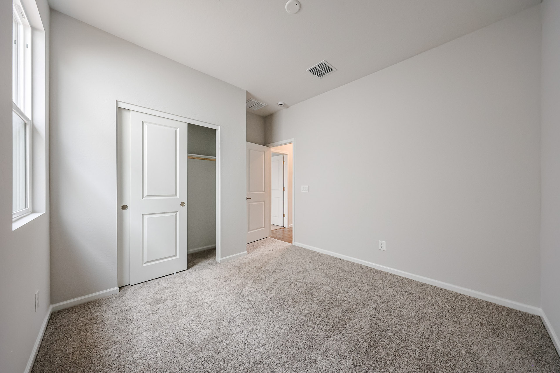 A hallway with white doors.