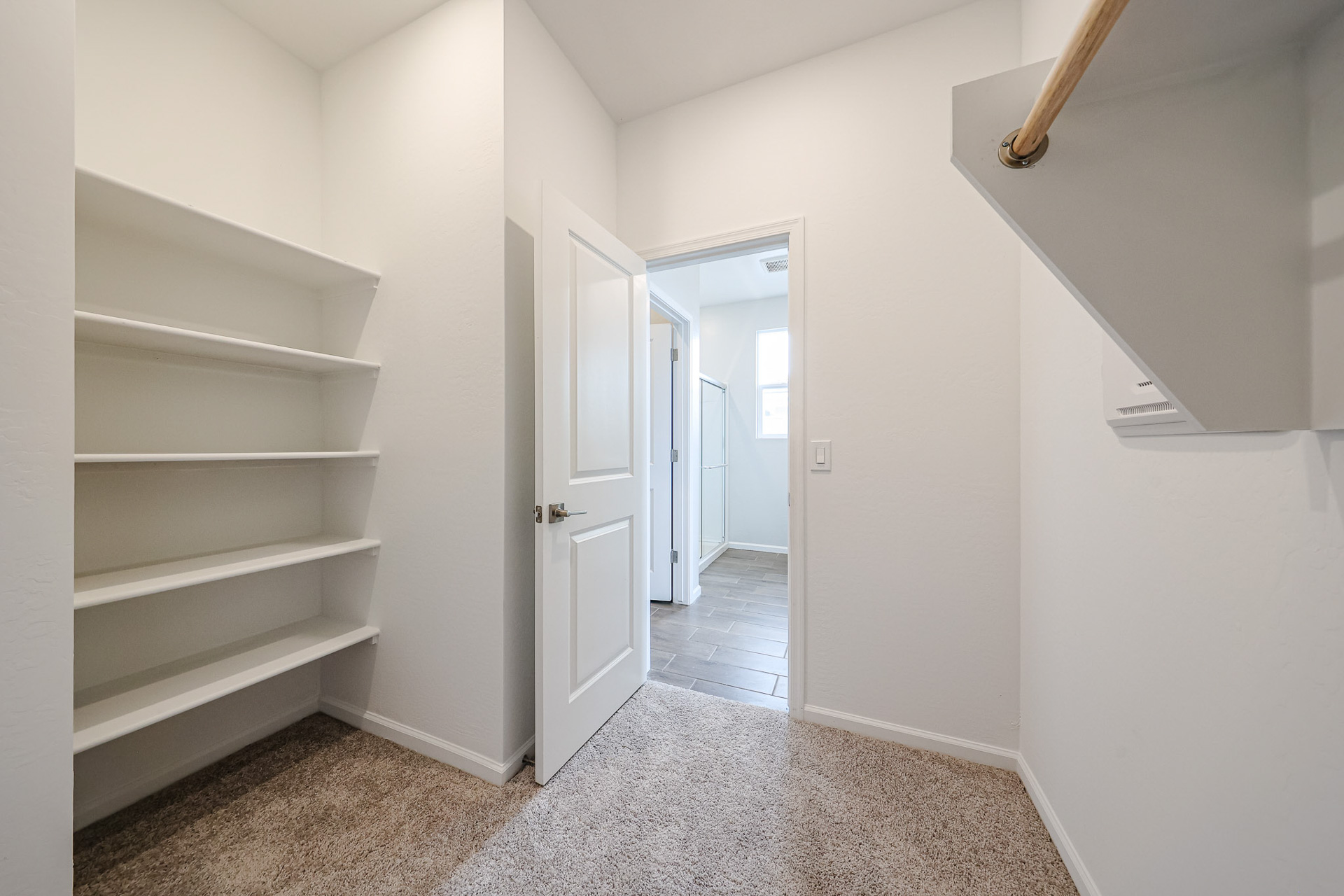 A hallway with white walls.