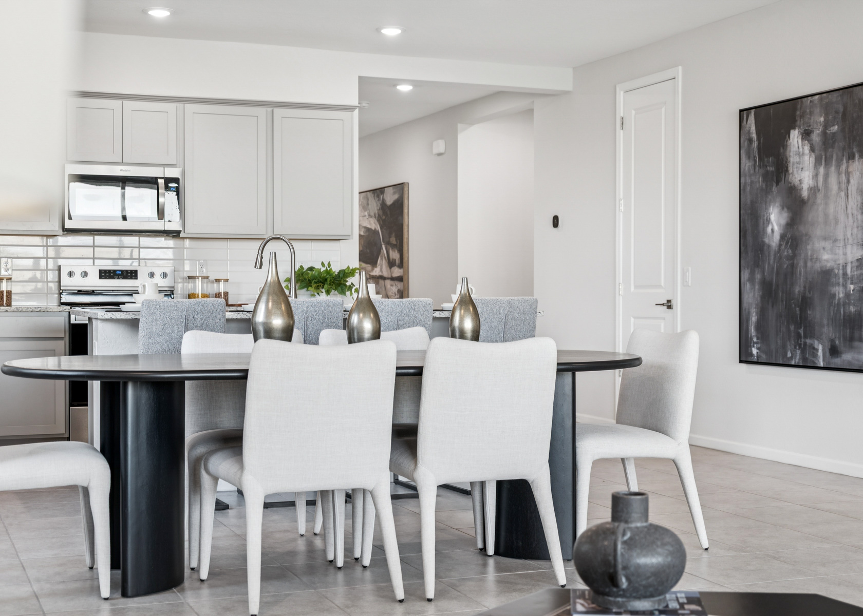 A kitchen with a table and chairs.
