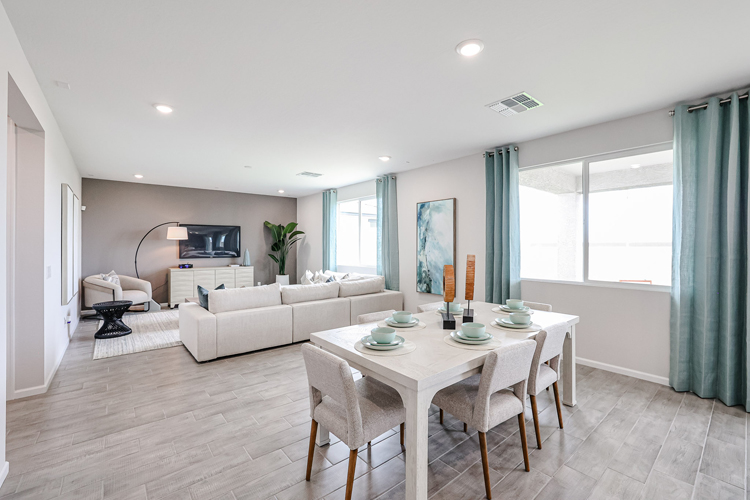 A living room with a table and chairs.