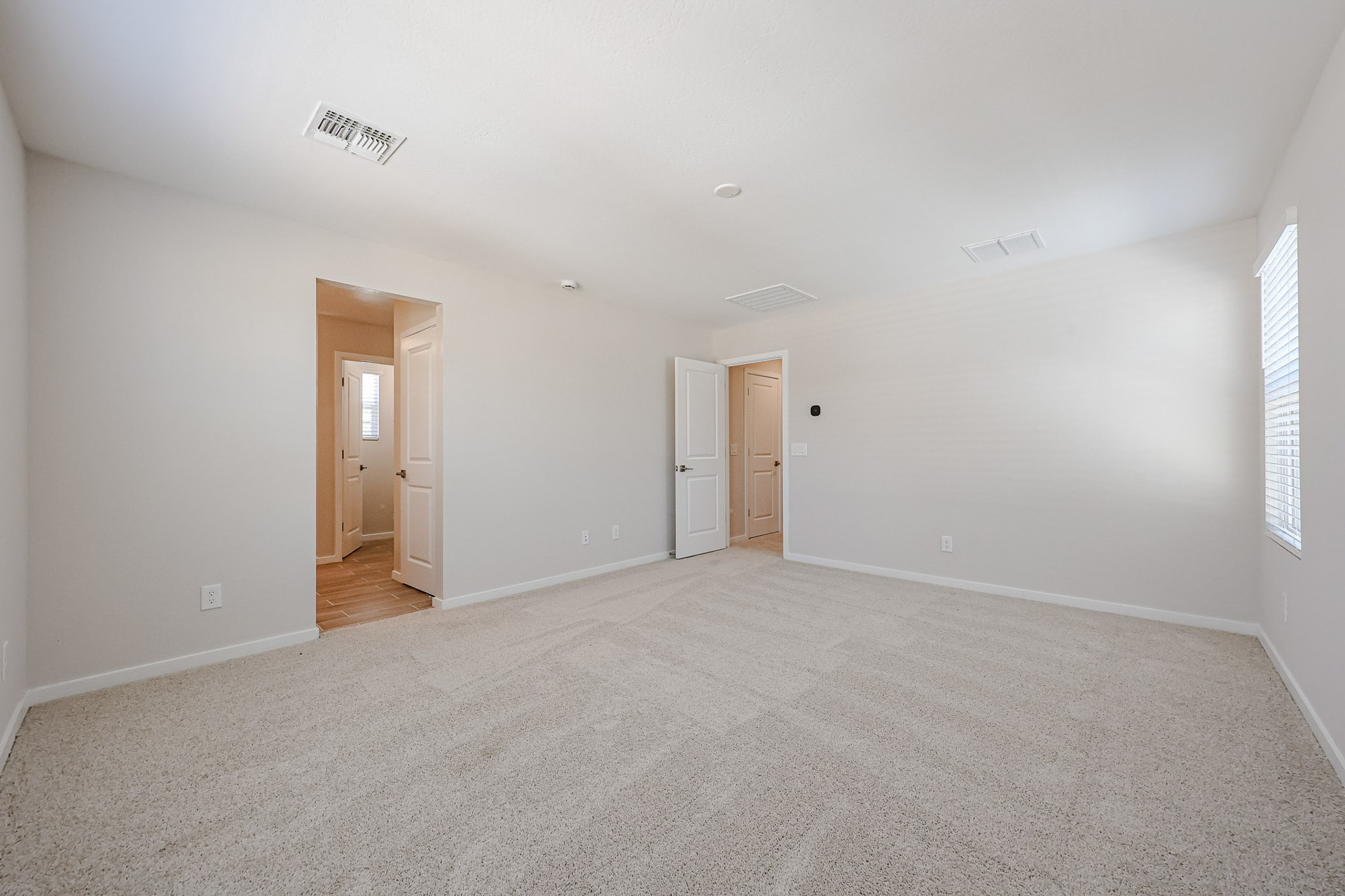 A room with white walls and doors.