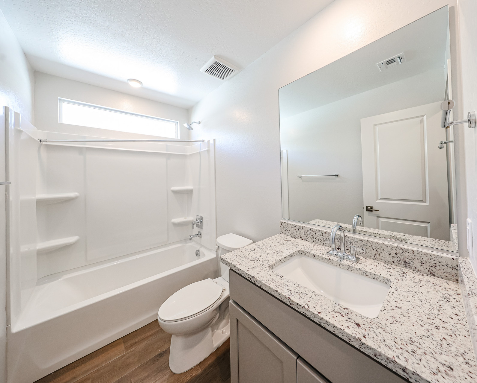 A bathroom with a tub sink and toilet.