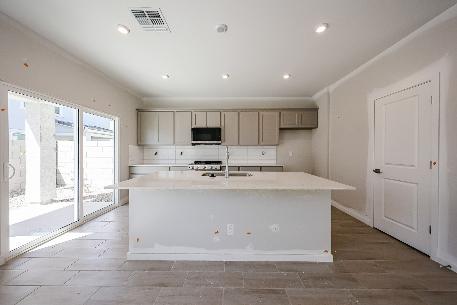A kitchen with white cabinets.