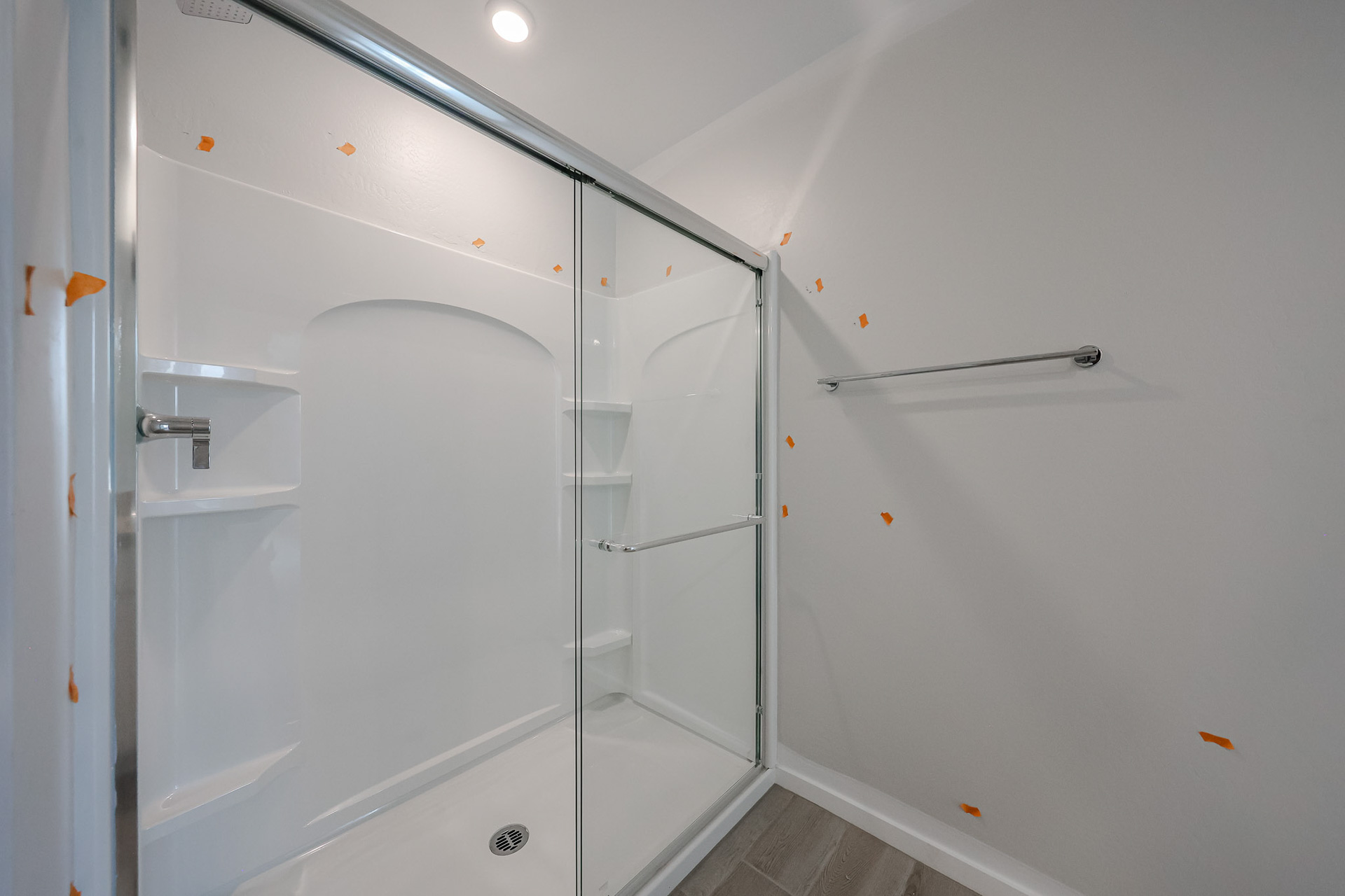 A shower with a glass door.