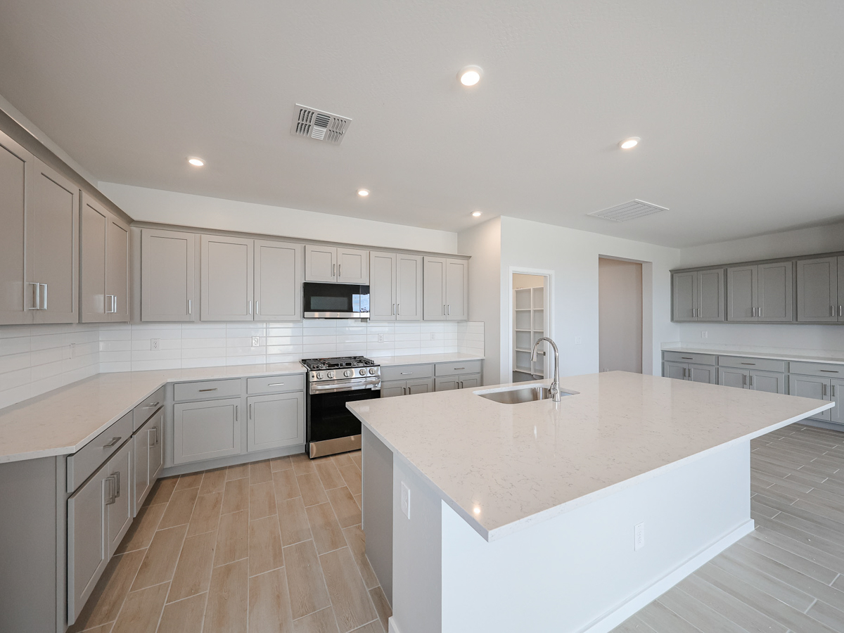 A kitchen with white cabinets.