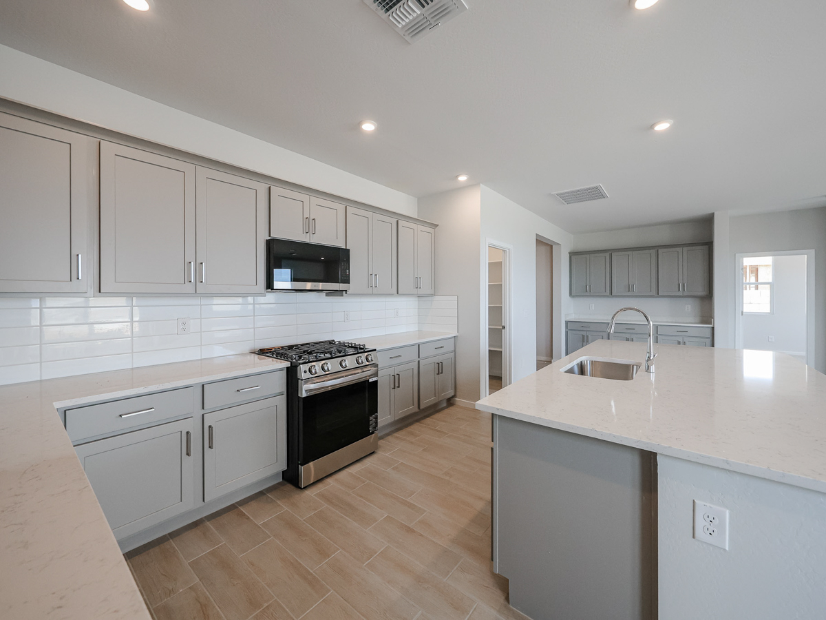 A kitchen with white cabinets.