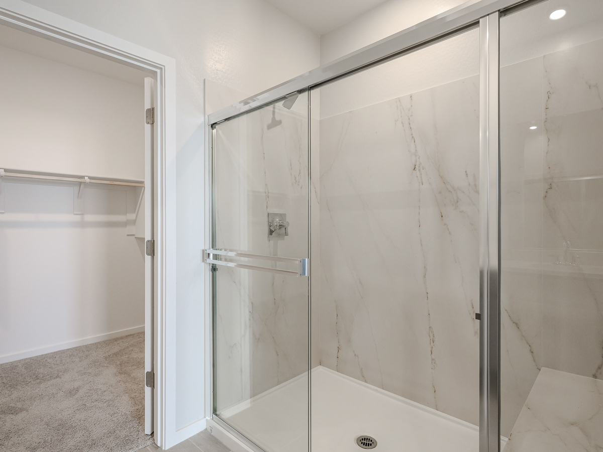 A shower with a glass door.