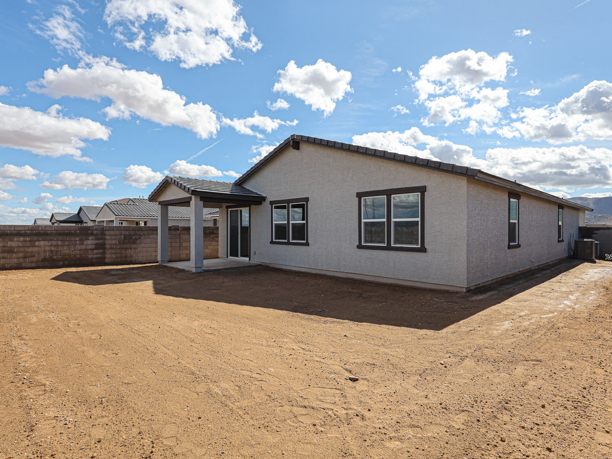 A house with a dirt yard.