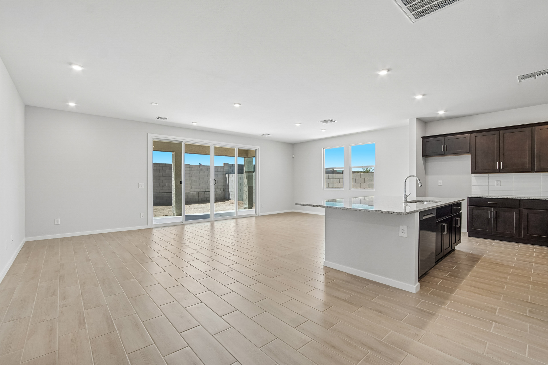 A large kitchen with a wood floor.