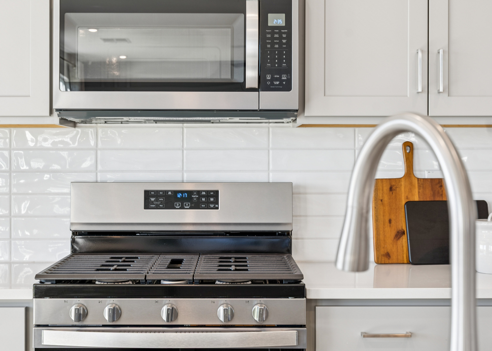 A kitchen with white cabinets.