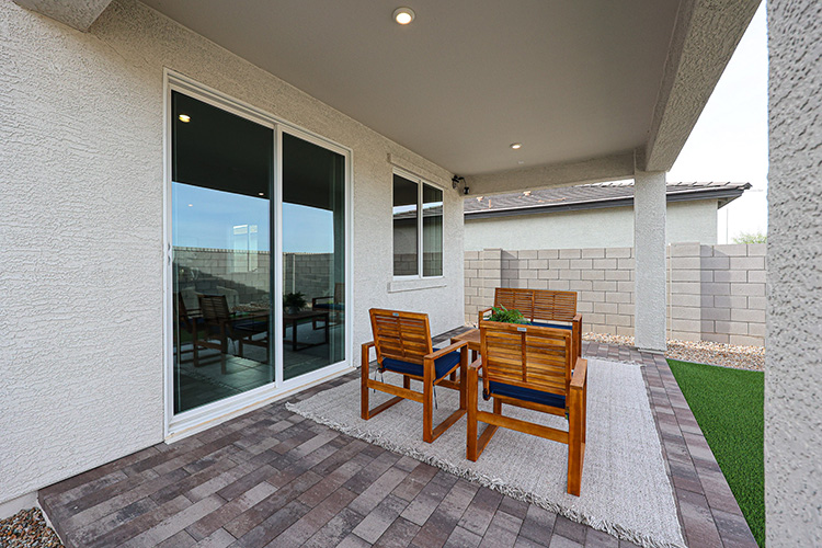A patio with chairs and a table.