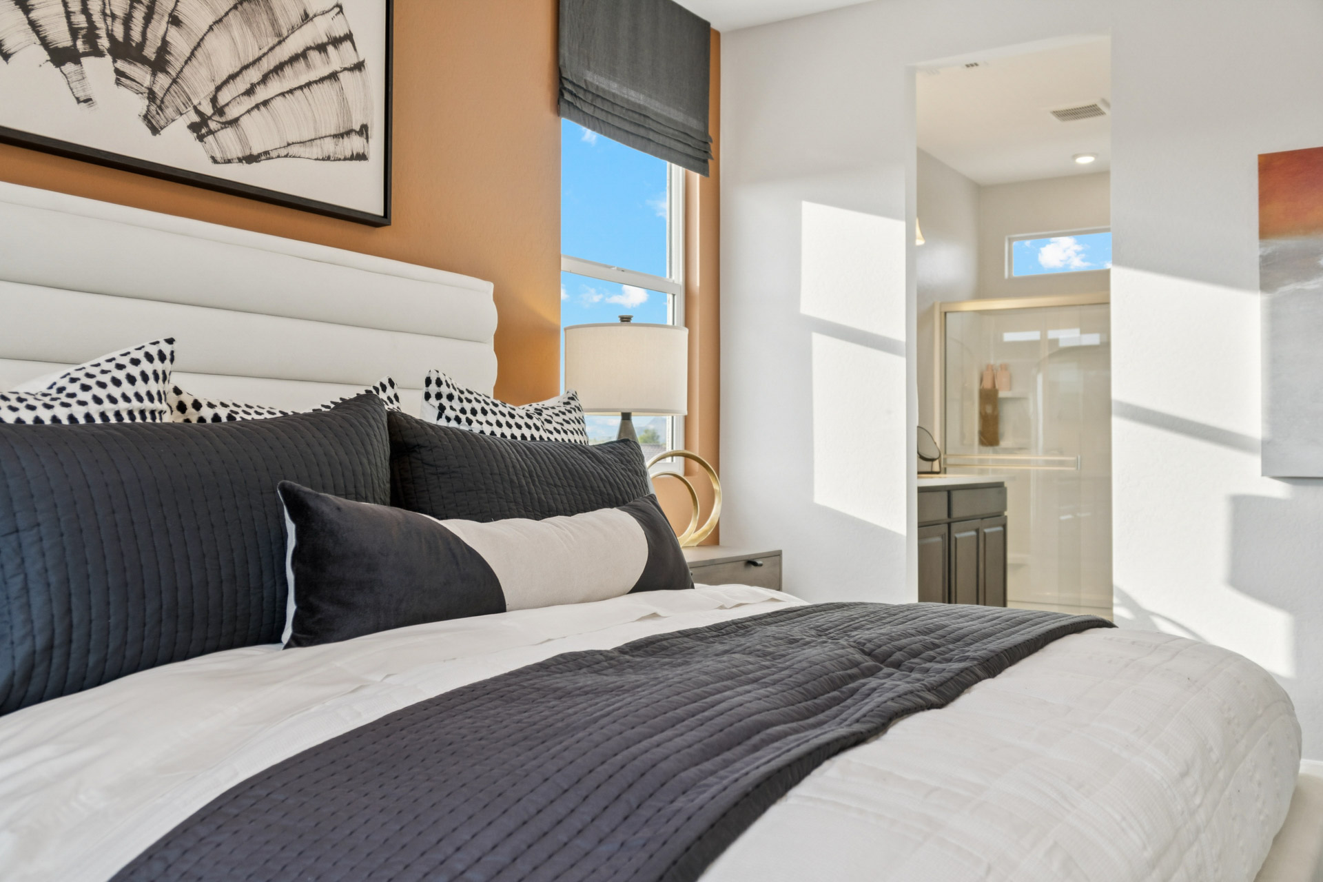 A bed with a large window.