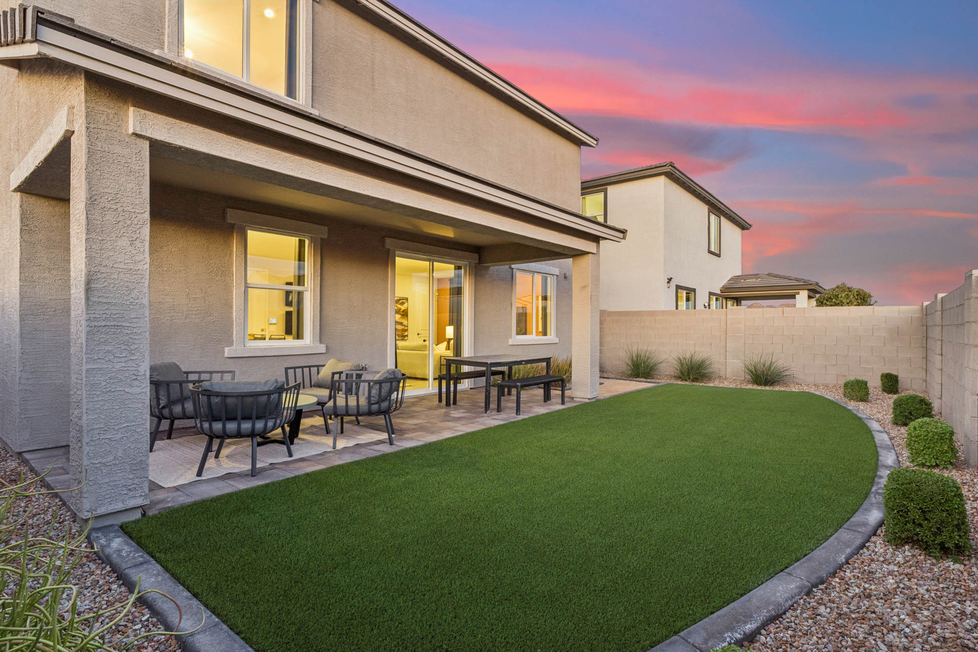 A backyard with a pool and a house.