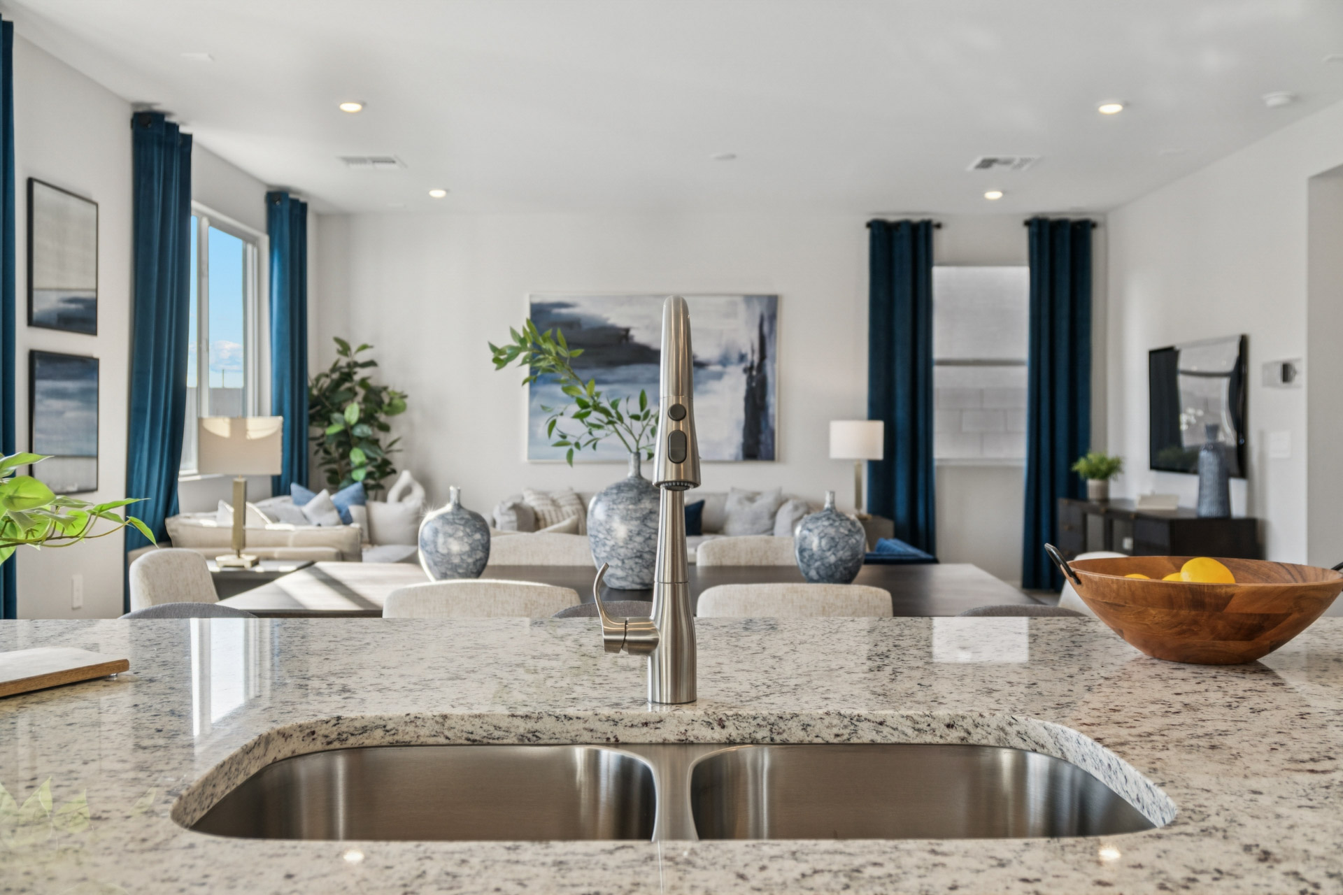 A modern looking kitchen with a large marble countertop.