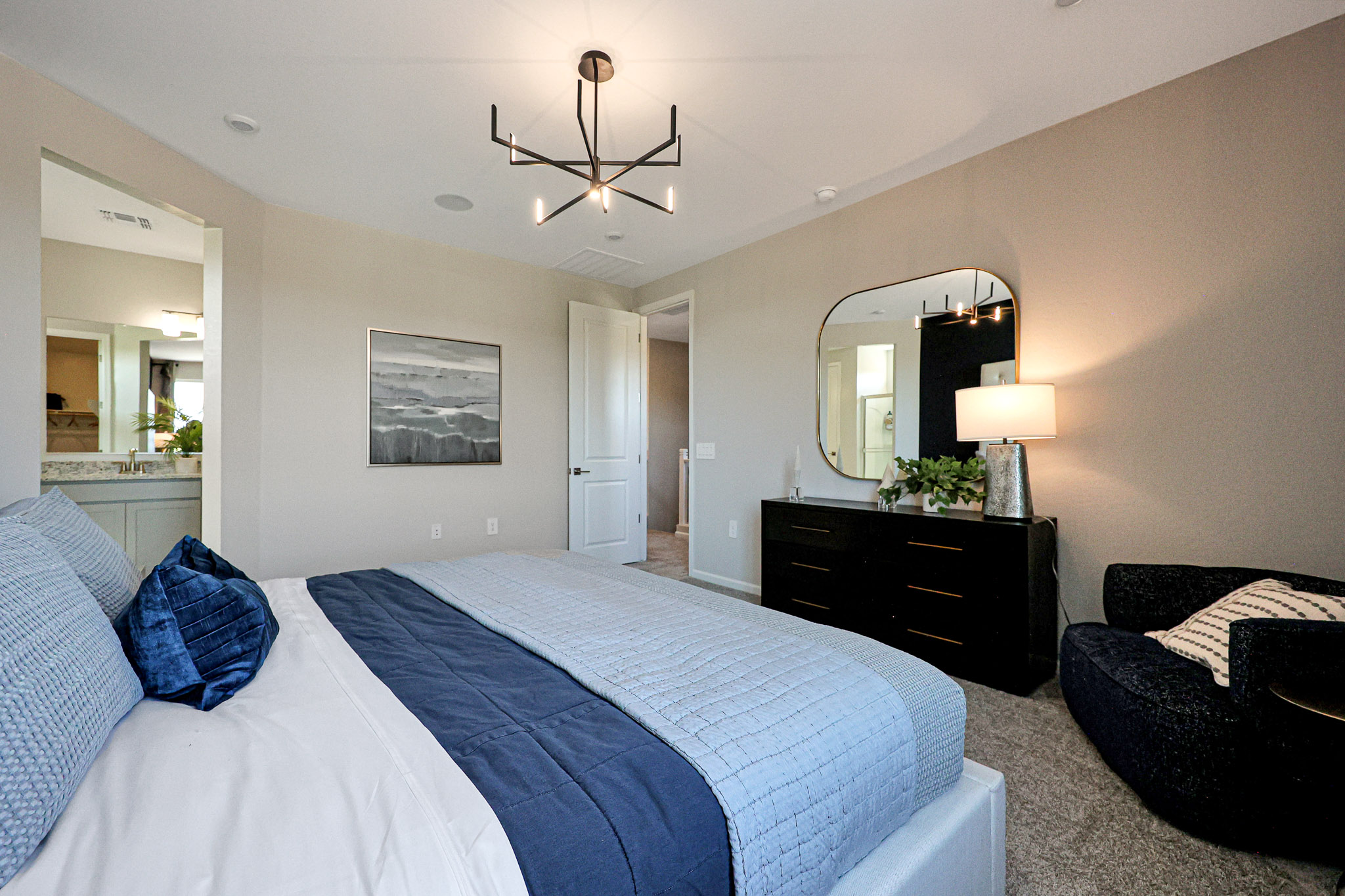 A hotel room with a bed and a mirror.