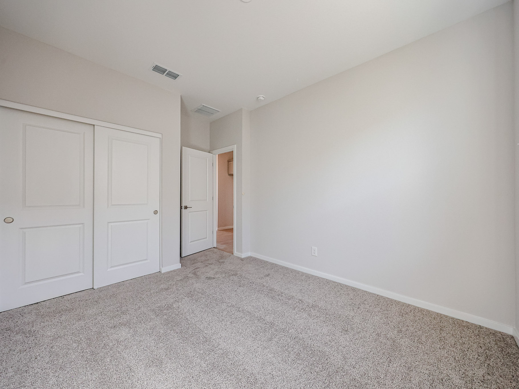 A hallway with white doors.