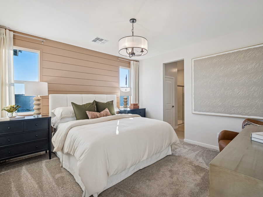 A bedroom with a bed and a couch.