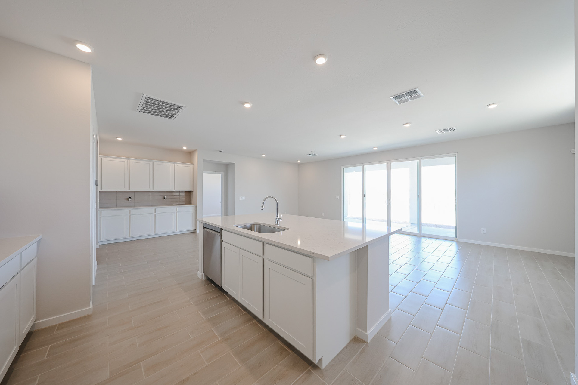 A kitchen with white cabinets.