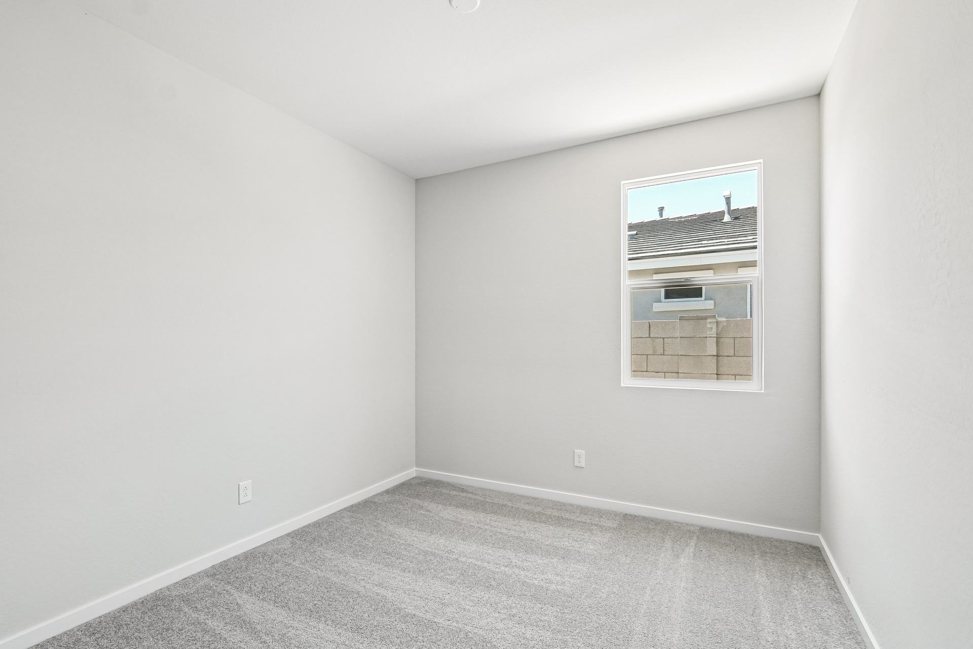 A room with a vent and a window.