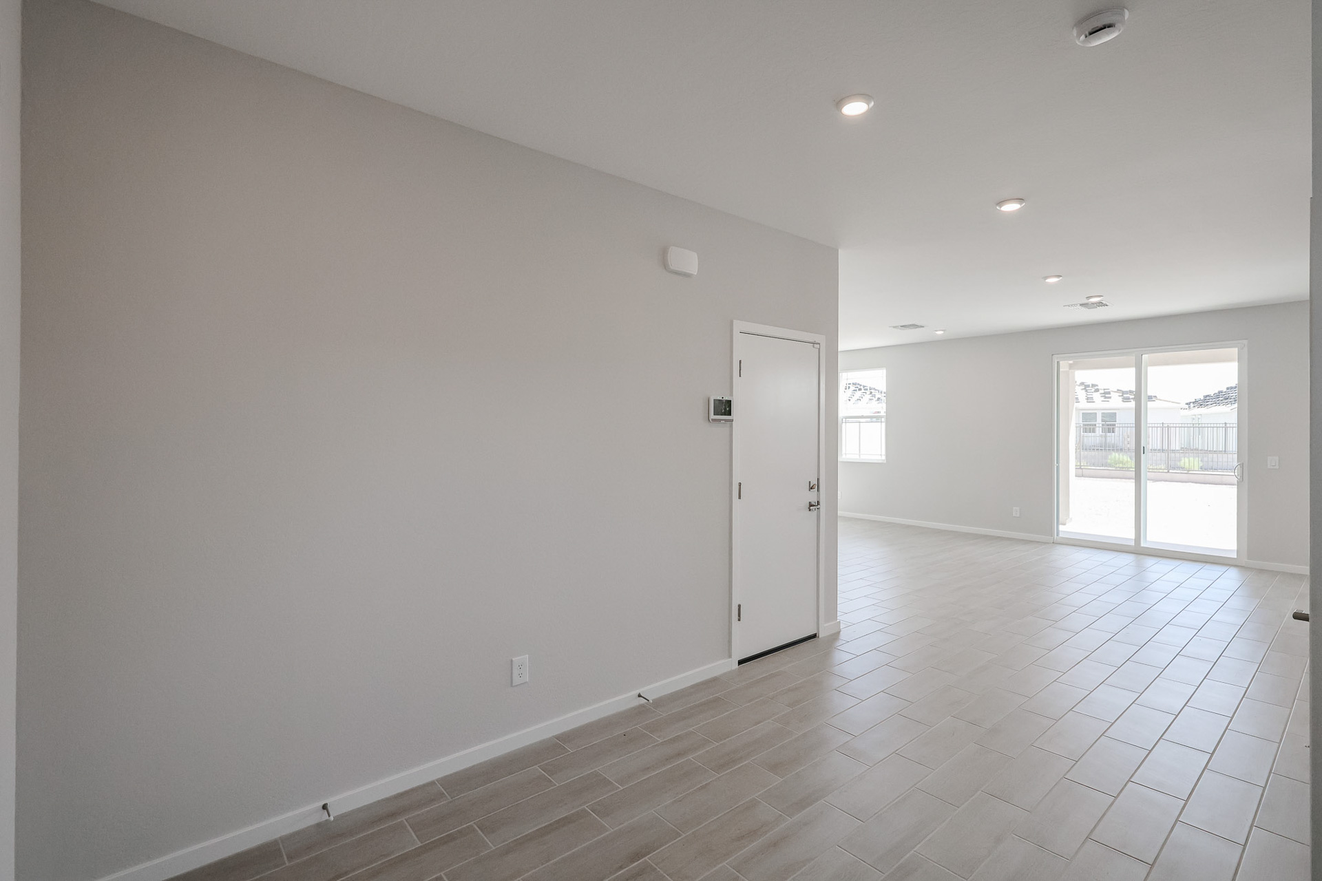 A room with white walls and a white door.