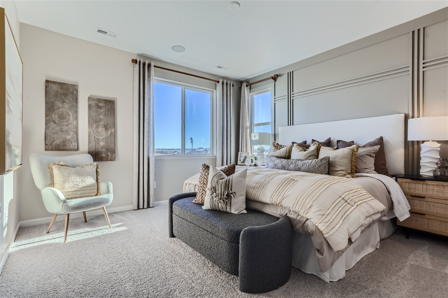 A bedroom with a bed and a chair.