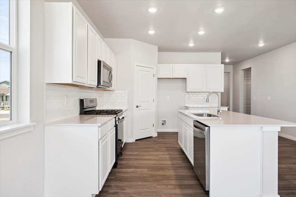 A kitchen with white cabinets.
