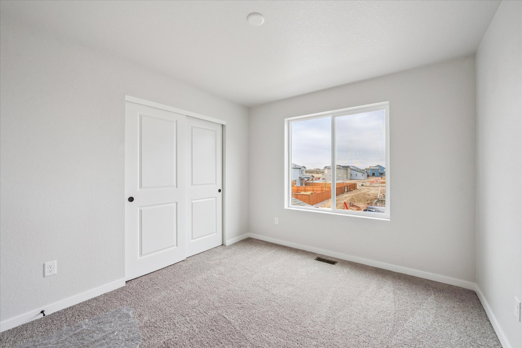 A room with white doors and a window.