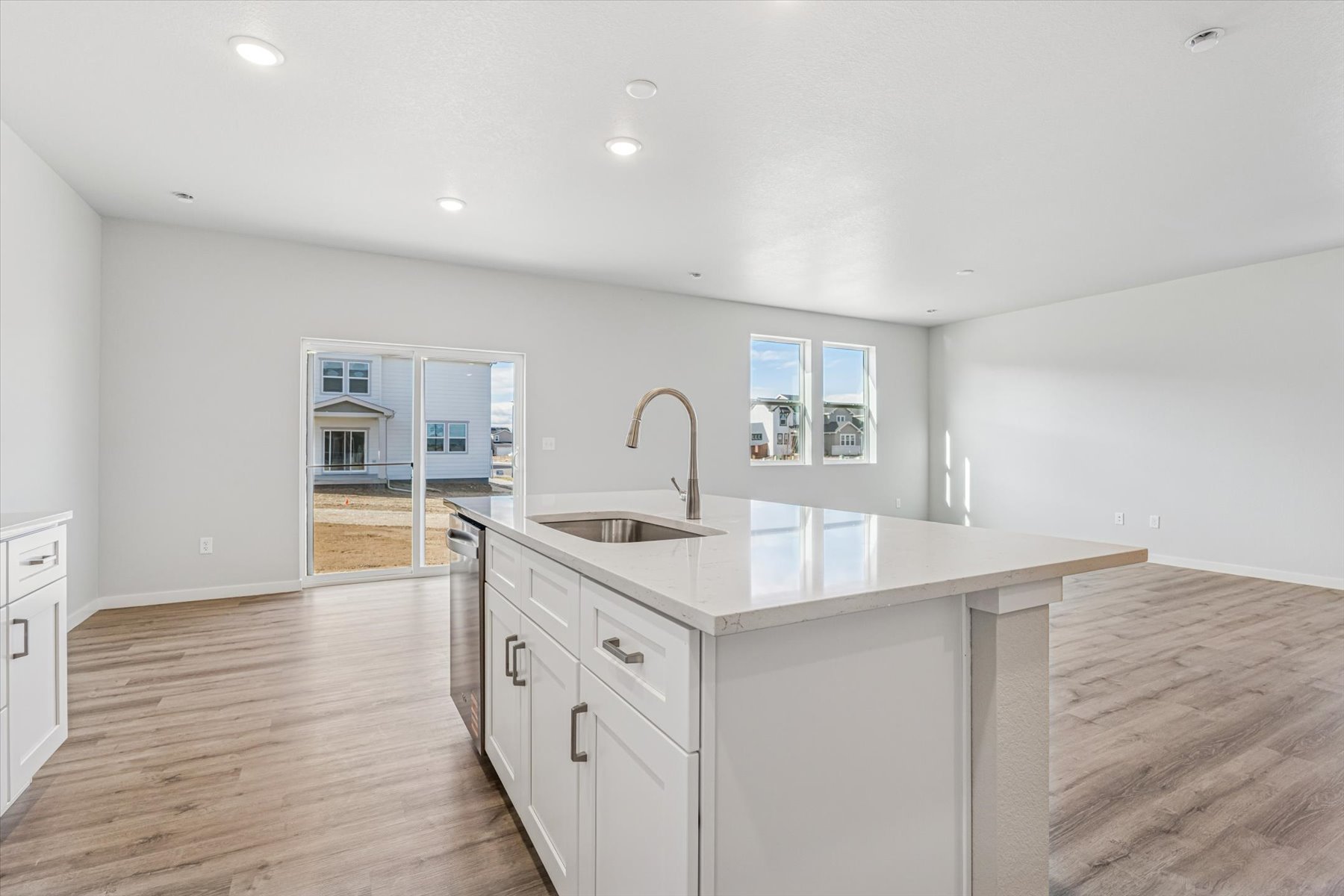 A kitchen with white cabinets.