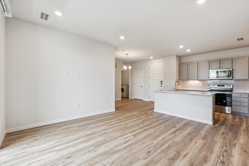 A kitchen with white cabinets.