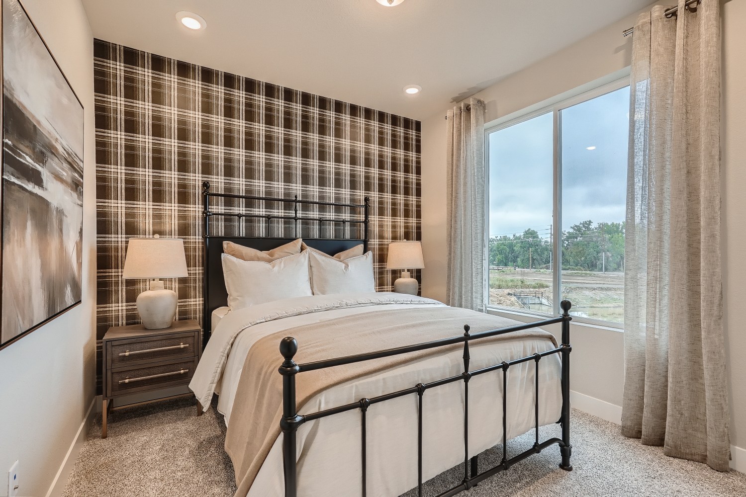 A bedroom with a large window.