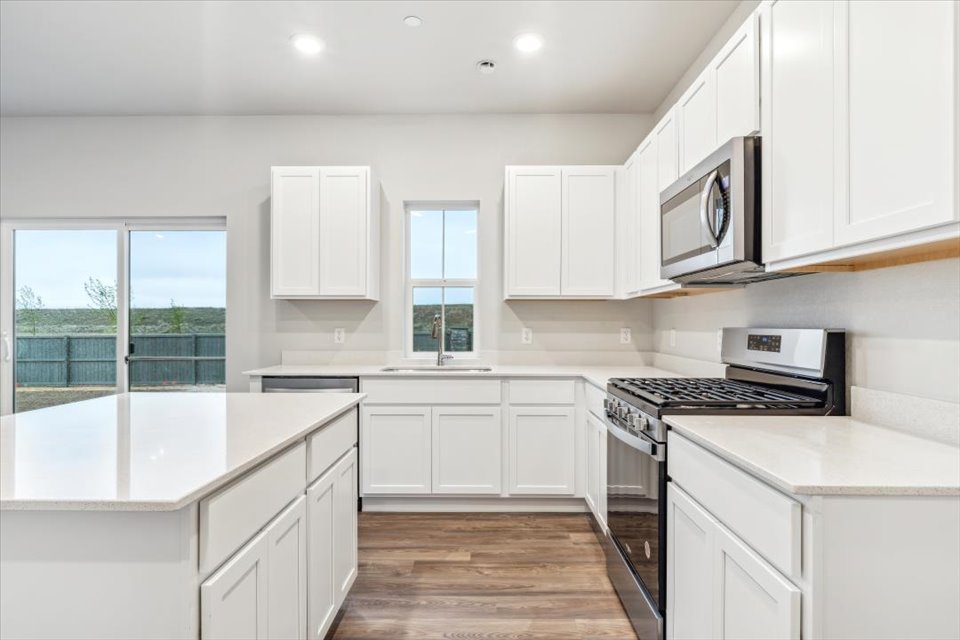 A kitchen with white cabinets.