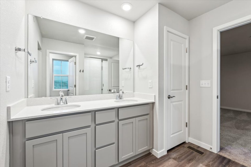 A bathroom with a large mirror.