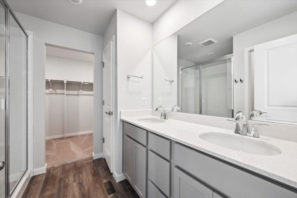 A bathroom with a large mirror.