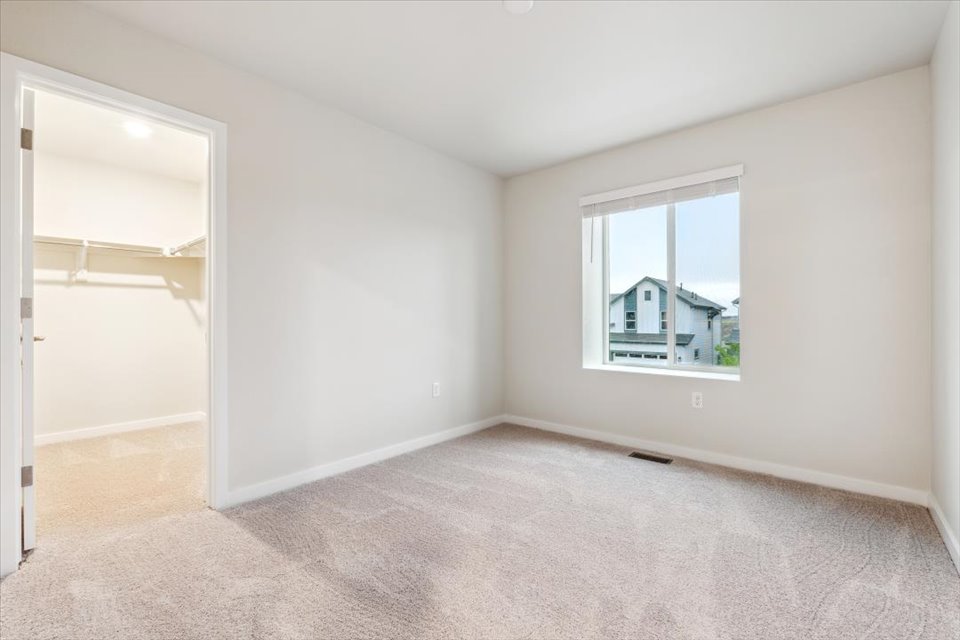 A room with a window and a carpet.
