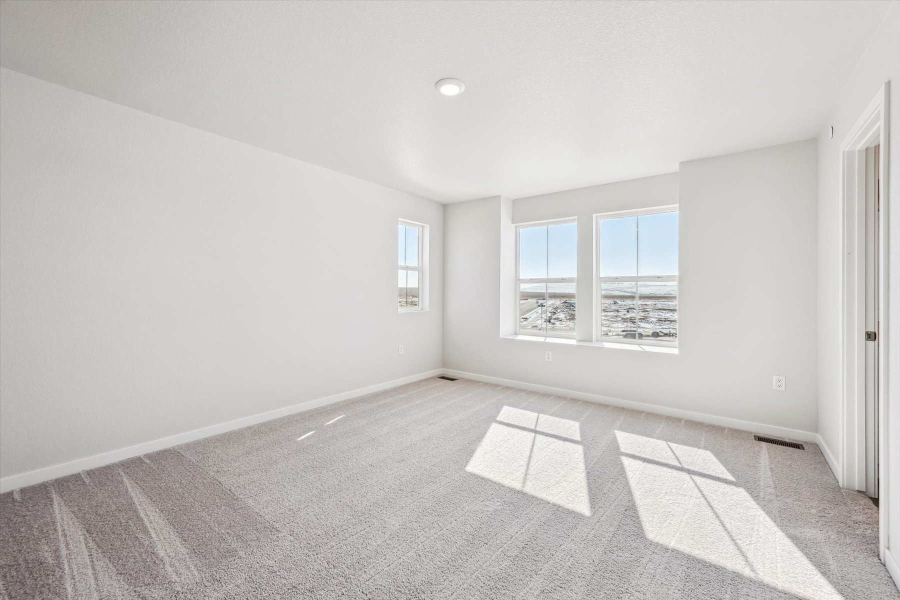 A room with a tile floor and windows.
